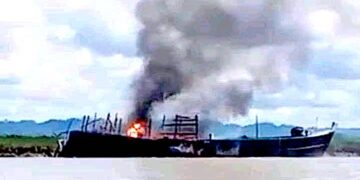 A boat fired upon by the Myanmar navy burns on the Mayu River in Rathedaung Township, Rakhine State on Wednesday. / Military Information Team