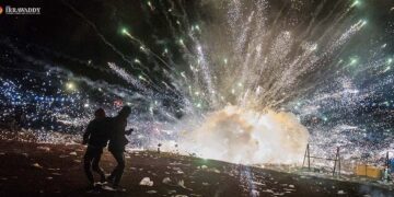 Spectators run to escape exploding fireworks that fell from a hot-air balloon at the Taunggyi Fire Balloon Festival on Wednesday. / Aung Kyaw Htet / The Irrawaddy