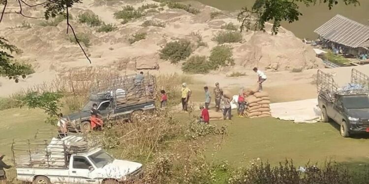 Rice sacks being unloaded on the Thai side of the Salween River.