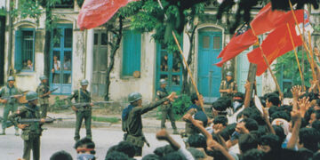 Troops confront pro-democracy demonstrators on a street in Yangon in August 1988.