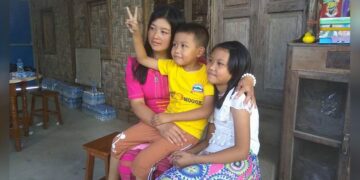 Nang Mo Hom with her son and daughter at her home after her release. / Sai Thein Shwe / Supplied