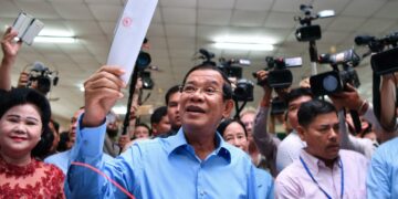 Cambodian Prime Minister Hun Sen prepares to cast his vote during the general election in 2018. / AFP via Bangkok Post