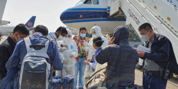 Medics and Yangon International Airport airport officials are seen near the plane on which a suspected coronavirus patient traveled from China. / Ministry of Health and Sports