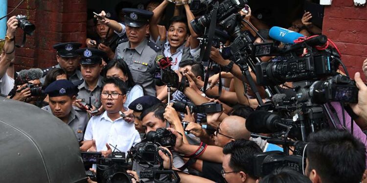 Reuters reporters Wa Lone and Kyaw Soe Oo are led away by police after being convicted and sentenced to seven years’ imprisonment for violating the Official Secrets Act at Inn Sein Court in Yangon on Sept. 3, 2018. / Myo Min Soe / The Irrawaddy