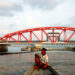 A fisherman passes by the Chinese-owned CNPC oil-pumping jetty on Madae Island, a site where huge oil tankers dock in Kyaukphyu Township in southern Rakhine State in 2017. / Moe Myint / The Irrawaddy
