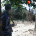 A border policeman stands in Wa Piek, a Muslim village located near a police outpost in Maungdaw Township. It has been burned down. / Moe Myint / The Irrawaddy