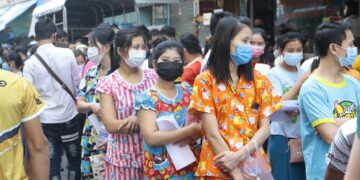 Migrant workers queue up for COVID-19 testing at an apartment in Samut Sakhon, Thailand on Dec. 20, 2020.  / Arnun Chonmahatrakool / Bangkok Post