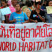 Members of Khon Kaen Slum Network community group hold a banner during a rally outside the United Nations building in Bangkok, Thailand, October 3, 2016. / Reuters