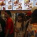 Customers line up to buy fried chicken at a KFC branch during its opening day in Rangoon, June 30, 2015. / Soe Zeya Tun / Reuters