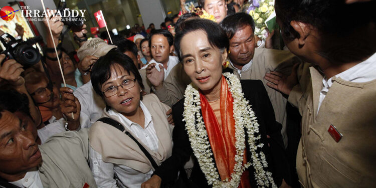 Dr. Tin Mar Aung (left of center, wearing glasses) accompanies Daw Aung San Suu Kyi in 2013. / The Irrawaddy