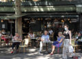 People spend time at a cafe in Paris on June 2, 2020, as an easing of anti-coronavirus business restrictions in France allowed restaurants, bars and coffee shops to reopen for the first time in about two-and-a-half months. / KYODO