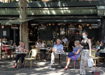 People spend time at a cafe in Paris on June 2, 2020, as an easing of anti-coronavirus business restrictions in France allowed restaurants, bars and coffee shops to reopen for the first time in about two-and-a-half months. / KYODO