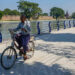 A man rides a bicycle past Mandalay Palace. / The Irrawaddy