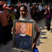 A mourner with U Ko Ni’s portrait at his funeral on January 30, 2017, in Yangon. / The Irrawaddy