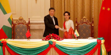 Myanmar State Counselor Daw Aung San Suu Kyi shakes hands with Chinese President Xi Jinping at a signing ceremony in Naypyitaw on Saturday. / / Nyein Chan Nyein / EPA / POOL