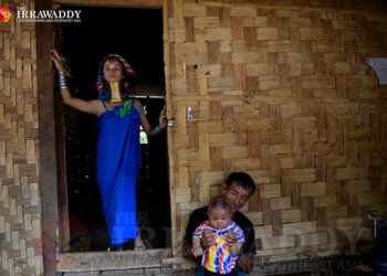 A Kayan Long Neck woman goes about her daily life after seeing her income drop due to a lack of tourists in Ban Nai Soi, Mae Hong Son, Thailand. / Jittrapon Kaicome / The Irrawaddy