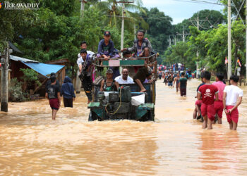 Residents of Hangan Village, in Ye Township, wade through flood waters on Monday, Aug. 12, 2019. / Myo Min Soe / The Irrawaddy