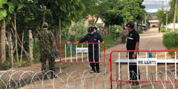 Guards at the entrance of a factory in Mae Sot under lockdown.