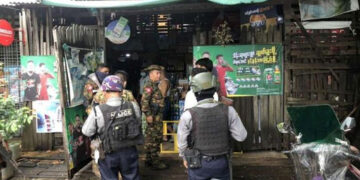 Junta forces arrive at a shop in Yangon’s Hlaing Township where a married couple were shot by unknown gunmen on Thursday. / Office of the Commander in-Chief of Defense Services