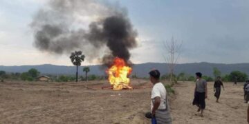 Villagers burn the body of a civilian killed during shootouts with junta forces in Kani Township on May 6.