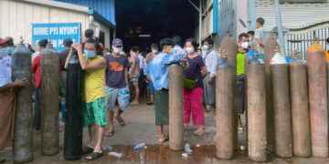 People queue to refill oxygen cylinders at an oxygen-producing plant in Yangon’s South Okkalapa Industrial Zone on July 9. / The Irrawaddy