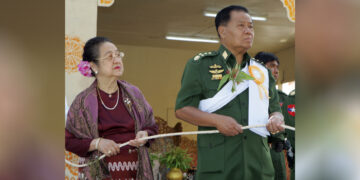 Than Shwe (right) and his wife Daw Kyaing Kyaing (left) attend a Buddhist ceremony in March 2009. / Khin Maung Win