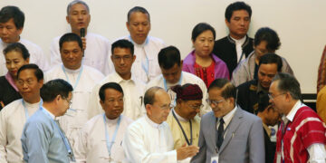 U Aung Naing Oo (last row, second from left), U Hla Maung Shwe (last row, third from left) and Dr. Min Zaw Oo (middle row, third from left) at the signing ceremony of the draft nationwide ceasefire text between ethnic armed groups and the U Thein Sein government in Yangon in March 2015, when former chief peace negotiator U Aung Min and President U Thein Sein (both in front row, left) were present. / The Irrawaddy