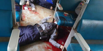 Police officers lie in pools of blood on a train in Yangon after being shot by unknown attackers.