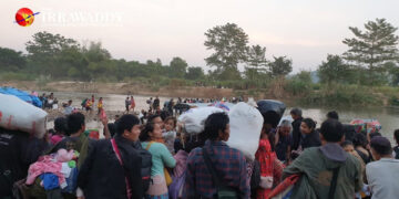 Civilians try to cross the Thaung Yin River to take shelter on the Thai side on Sunday after the junta's shelling of civilian areas near Myawaddy in Karen State. / The Irrawaddy