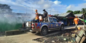 A local charity sprays disinfectant in a market in Sittwe as a COVID-19 prevention measure.