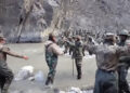 This video frame grab taken from footage recorded in mid-June 2020 and released by China Central Television on Feb. 20, 2021 shows Chinese (foreground) and Indian (right, background) soldiers during a clash on the Line of Actual Control in the Galwan Valley, in the Karakoram Mountains in the Himalayas. / AFP / CCTV