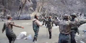 This video frame grab taken from footage recorded in mid-June 2020 and released by China Central Television on Feb. 20, 2021 shows Chinese (foreground) and Indian (right, background) soldiers during a clash on the Line of Actual Control in the Galwan Valley, in the Karakoram Mountains in the Himalayas. / AFP / CCTV