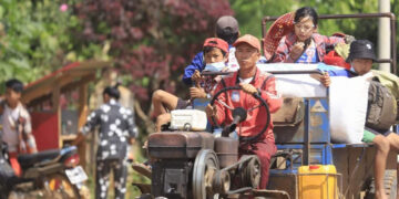 A family flees Mobye in Shan State on Sunday after the town was bombarded by junta forces. / John Alben