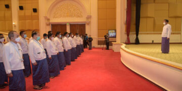 The Myanmar Press Council’s new members take oaths before coup leader Min Aung Hlaing (on stage) on Nov. 24 in Naypyitaw. / Cincds