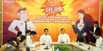 Former navy lieutenant commander turned telecom CFO U Thein Aung, center right, at a Mytel promotional event.