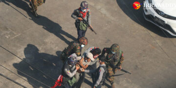 Riot police and soldiers arrest two men after launching a raid on Thida Street in Yangon’s Tamwe Township to crack down on anti-regime protesters on March 6. / The Irrawaddy