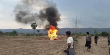 Villagers burn the dead body of villager who was killed during shootouts with junta forces near Kin Village in Kani Township on May 6.