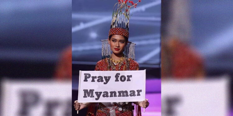 Miss Universe contestant Thuzar Wint Lwin holds a placard saying "Save Myanmar" during the competition. / Thuzar Wint Lwin / Facebook
