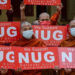 Buddhist monks in Mandalay hold placards reading "We Support NUG-National Unity Government" during a march against the military regime on April 21, 2021. / Tayzar San