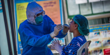 A swab sample is taken from a woman in Yangon in Oct 2020. / The Irrawaddy
