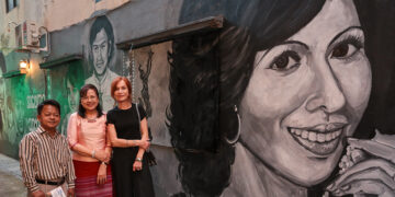 Ko Aung Htun Lay, Myanmar Academy Award-winning actress Daw Swe Zin Htaik and award-wining French actress Isabelle Huppert visit a street art exhibition featuring murals depicting scenes from three classic films from the golden age of Burmese cinema by YGNWALLS artists. The exhibition is being staged as part of the ongoing 7th MEMORY! Film Festival, which runs until Nov. 24 at the Waziya Cinema and Mahabandoola Park in Yangon. 