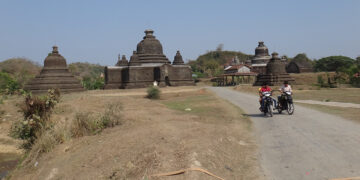 Local people pass by Htukkan Thein temple on March 17, a day before the Myanmar Army opened fire in downtown Mrauk-U.   / Moe Myint / The Irrawaddy