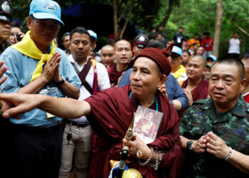 The Buddhist monk known in Myanmar as Maing Hpone Sayadaw greets supporters after praying near the Tham Luang cave complex in Thailand’s northern province of Chiang Rai on June 30. / Reuters