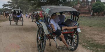 A Chinese tourist rides in a horse-drawn carriage in Bagan in July 2019. / Zaw Zaw / The Irrawaddy