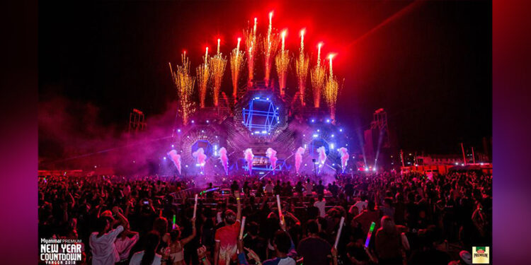 People celebrate the Myanmar Premium New Year's Eve 2018 Countdown EDM festival in Yangon on December 31, 2017. / Myanmar Premium
