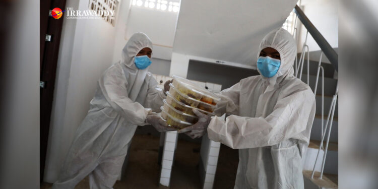 Volunteers deliver food at a COVID-19 quarantine center in Yangon in April. / Myo Min Soe / The Irrawaddy