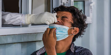 A nasal swab sample is taken from a truck driver in Yangon. / Htet Wai / The Irrawaddy