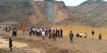 Rescue workers, police and local administration officials inspect the site of a landslide in Seikmu village in Kachin State’s Hpakant jade-mining region, which killed at least 17 people and injured two on Sunday. / Ko Zaw Moe Htet