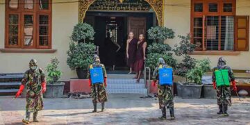 Myanmar military personnel sanitize one of Mandalay's landmarks, the Maha Gandhayon Buddhist Monastery, on March 30, three days after the city announced its first confirmed case of COVID-19. / Zaw Zaw / The Irrawaddy