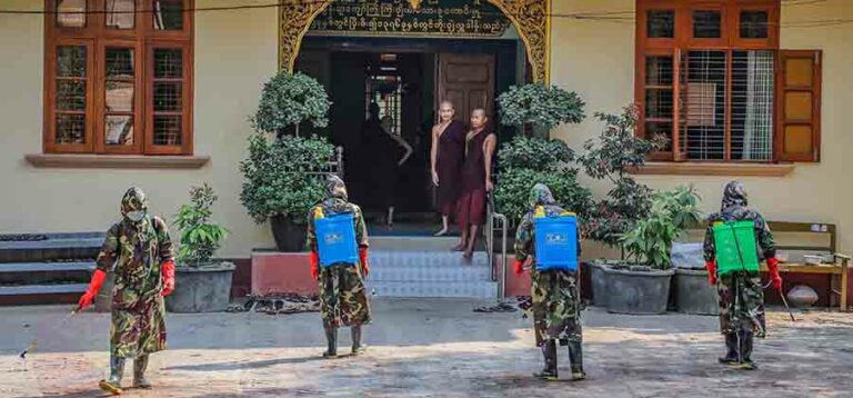 Myanmar military personnel sanitize one of Mandalay's landmarks, the Maha Gandhayon Buddhist Monastery, on March 30, three days after the city announced its first confirmed case of COVID-19. / Zaw Zaw / The Irrawaddy